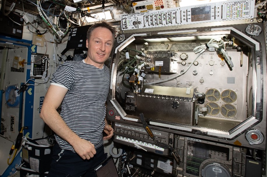 Matthias Maurer, ESA’s astronaut, with the Transparent Alloys instrument after its successful installation in MSG. Credits ESA and NASA